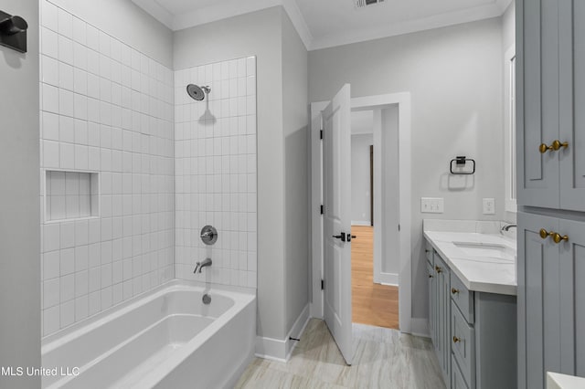 full bath featuring shower / bathtub combination, visible vents, ornamental molding, vanity, and baseboards