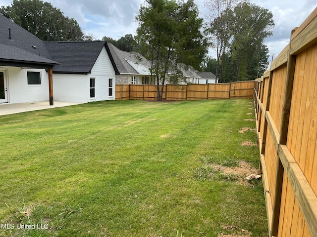 view of yard with a patio area and a fenced backyard