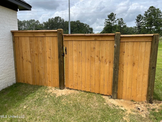 view of gate featuring fence