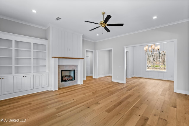 unfurnished living room featuring a tile fireplace, visible vents, crown molding, and light wood-style flooring