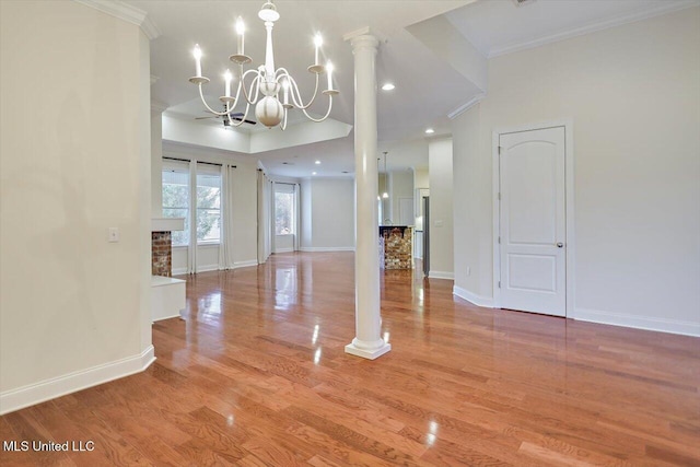 interior space with ornamental molding, light hardwood / wood-style flooring, ornate columns, and an inviting chandelier