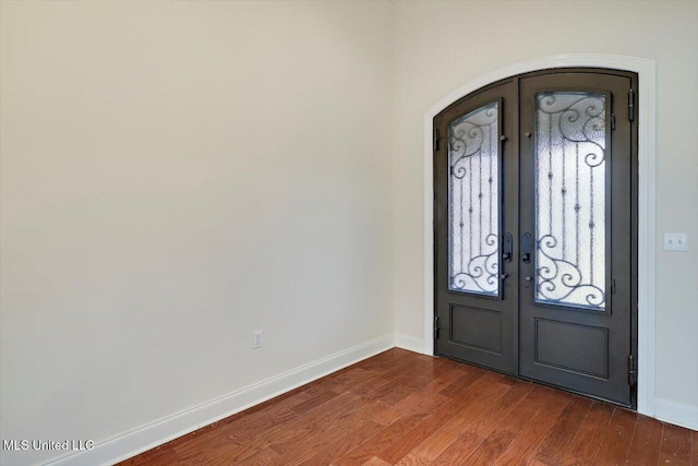 foyer entrance featuring wood-type flooring and french doors