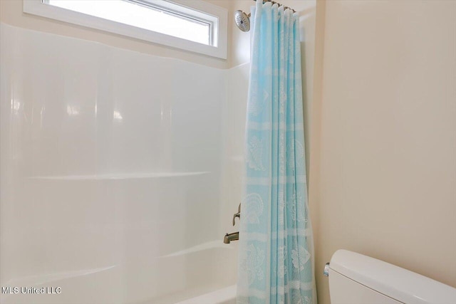 bathroom with toilet and shower / bathtub combination with curtain