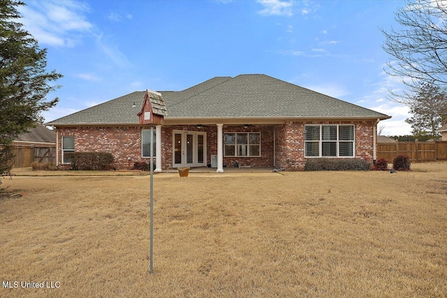 back of house with a lawn