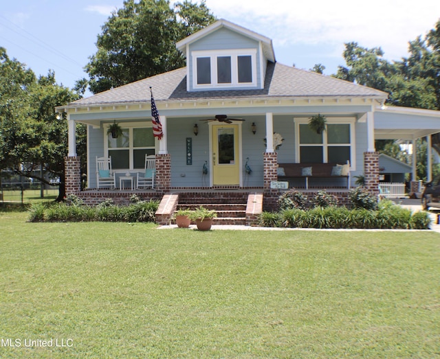 605 Magnolia St, Long Beach, MS 39560 - bungalow featuring a porch, a front yard, ceiling fan, and a shingled roof
