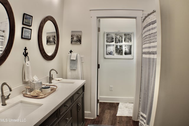 605 Magnolia St, Long Beach, MS 39560 - bathroom featuring wood finished floors and double vanity