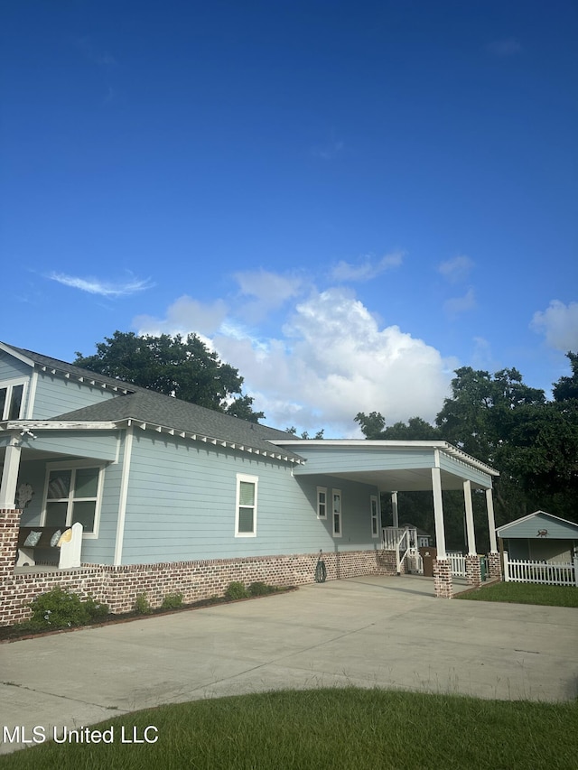 605 Magnolia St, Long Beach, MS 39560 - view of front of house with concrete driveway, an attached carport, and covered porch