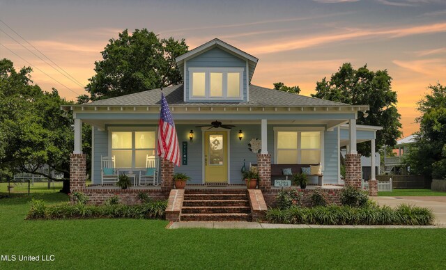 605 Magnolia St, Long Beach, MS 39560 - bungalow-style home with covered porch, a front yard, and roof with shingles