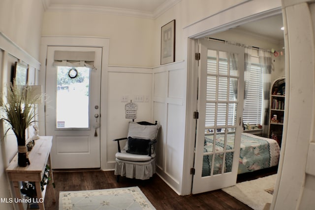 605 Magnolia St, Long Beach, MS 39560 - doorway with ornamental molding, dark wood-style floors, and a wainscoted wall
