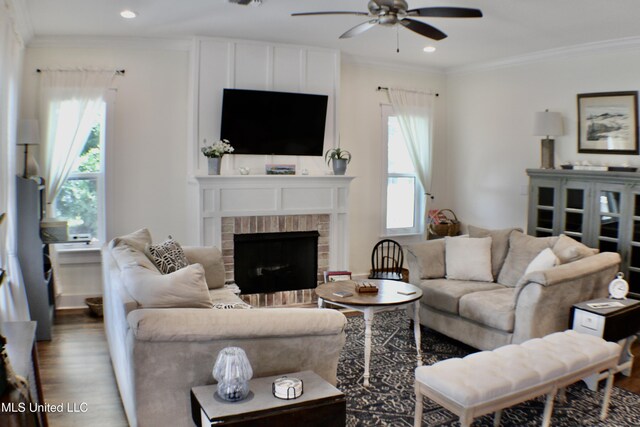 605 Magnolia St, Long Beach, MS 39560 - living area with ceiling fan, plenty of natural light, wood finished floors, a fireplace, and ornamental molding