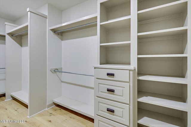 walk in closet featuring light hardwood / wood-style flooring