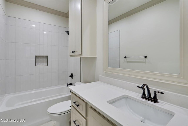 full bathroom featuring crown molding, vanity, toilet, and tiled shower / bath combo