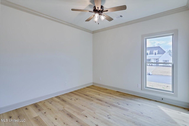 unfurnished room featuring ornamental molding, a wealth of natural light, ceiling fan, and light hardwood / wood-style flooring