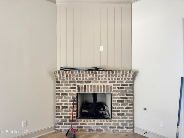 room details featuring a brick fireplace and hardwood / wood-style floors