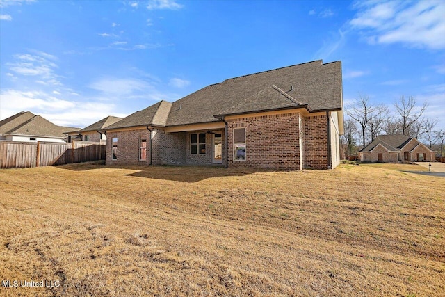 rear view of house with a yard