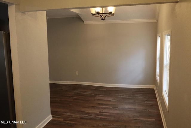 2411 14th St, Pascagoula, MS 39567 - unfurnished room with crown molding, healthy amount of natural light, dark wood-type flooring, baseboards, and a chandelier