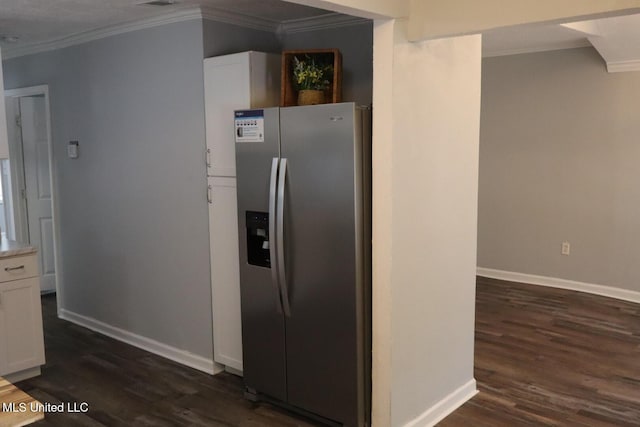 2411 14th St, Pascagoula, MS 39567 - kitchen with stainless steel fridge, crown molding, dark wood-style flooring, white cabinets, and baseboards