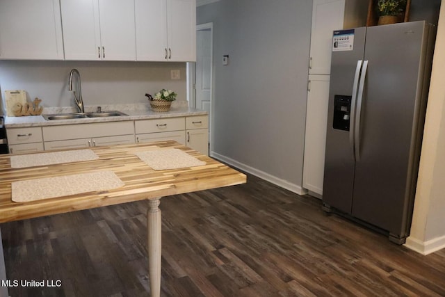 2411 14th St, Pascagoula, MS 39567 - kitchen featuring stainless steel refrigerator with ice dispenser, a sink, baseboards, and dark wood-style flooring