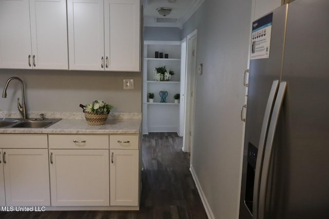 2411 14th St, Pascagoula, MS 39567 - kitchen with stainless steel refrigerator with ice dispenser, a sink, dark wood-style floors, and white cabinetry
