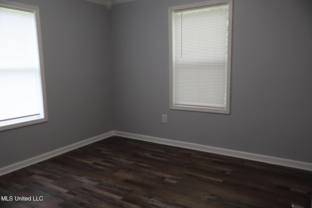 2411 14th St, Pascagoula, MS 39567 - spare room with dark wood-style floors, healthy amount of natural light, baseboards, and ornamental molding