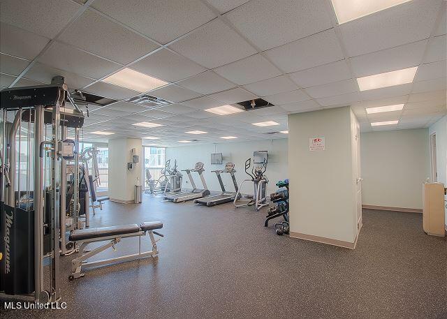 workout area featuring a paneled ceiling