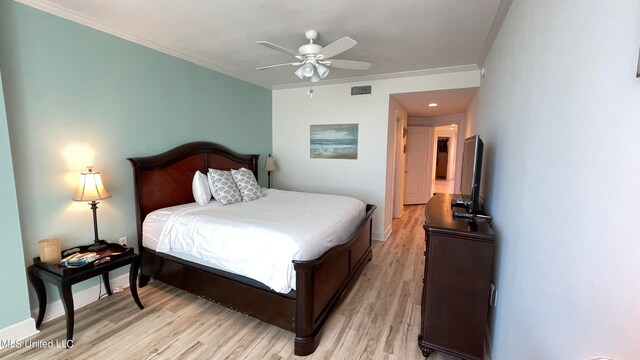 bedroom with crown molding, light hardwood / wood-style floors, and ceiling fan