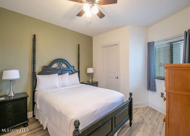 bedroom with light wood-type flooring and ceiling fan