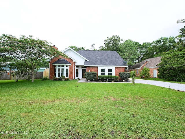 7869 Hilo Way, Diamondhead, MS 39525 - view of front facade featuring brick siding and a chimney