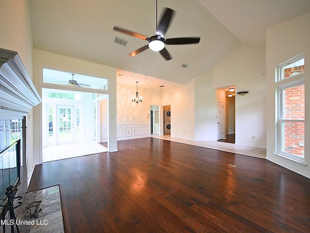 7869 Hilo Way, Diamondhead, MS 39525 - unfurnished living room with ceiling fan, high vaulted ceiling, wood finished floors, a chandelier, and a wainscoted wall