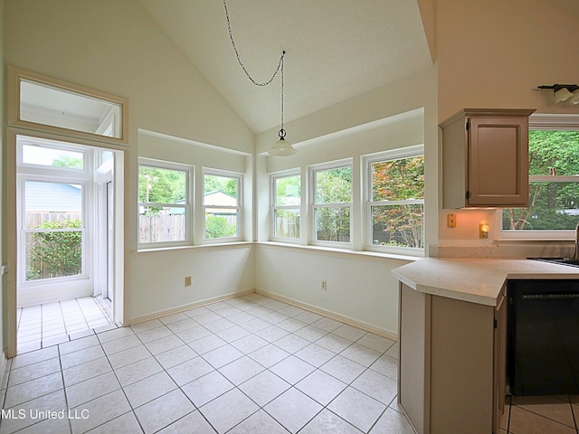 7869 Hilo Way, Diamondhead, MS 39525 - kitchen with black dishwasher, light countertops, lofted ceiling, light tile patterned floors, and a sink