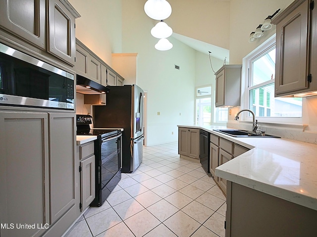 7869 Hilo Way, Diamondhead, MS 39525 - kitchen with black appliances, a sink, high vaulted ceiling, under cabinet range hood, and gray cabinetry