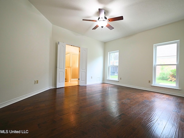 7869 Hilo Way, Diamondhead, MS 39525 - empty room featuring ceiling fan, dark wood-style floors, and baseboards
