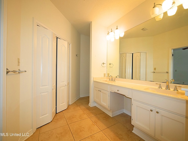 7869 Hilo Way, Diamondhead, MS 39525 - bathroom with tile patterned floors, double vanity, baseboards, and a closet