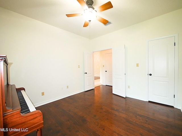 7869 Hilo Way, Diamondhead, MS 39525 - unfurnished bedroom featuring dark wood-type flooring, baseboards, and a ceiling fan