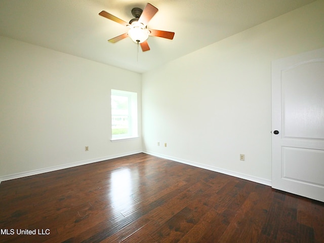 7869 Hilo Way, Diamondhead, MS 39525 - spare room featuring dark wood-type flooring, a ceiling fan, and baseboards