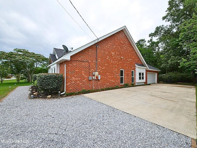 7869 Hilo Way, Diamondhead, MS 39525 - view of home's exterior with brick siding, driveway, and a garage