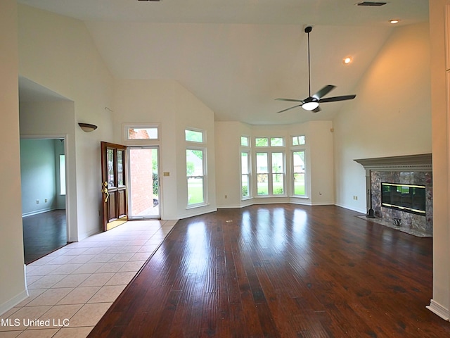 7869 Hilo Way, Diamondhead, MS 39525 - unfurnished living room featuring high vaulted ceiling, ceiling fan, hardwood / wood-style floors, a premium fireplace, and baseboards