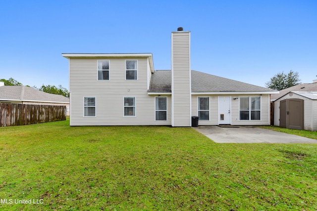 back of property featuring a lawn, a patio area, and a storage shed