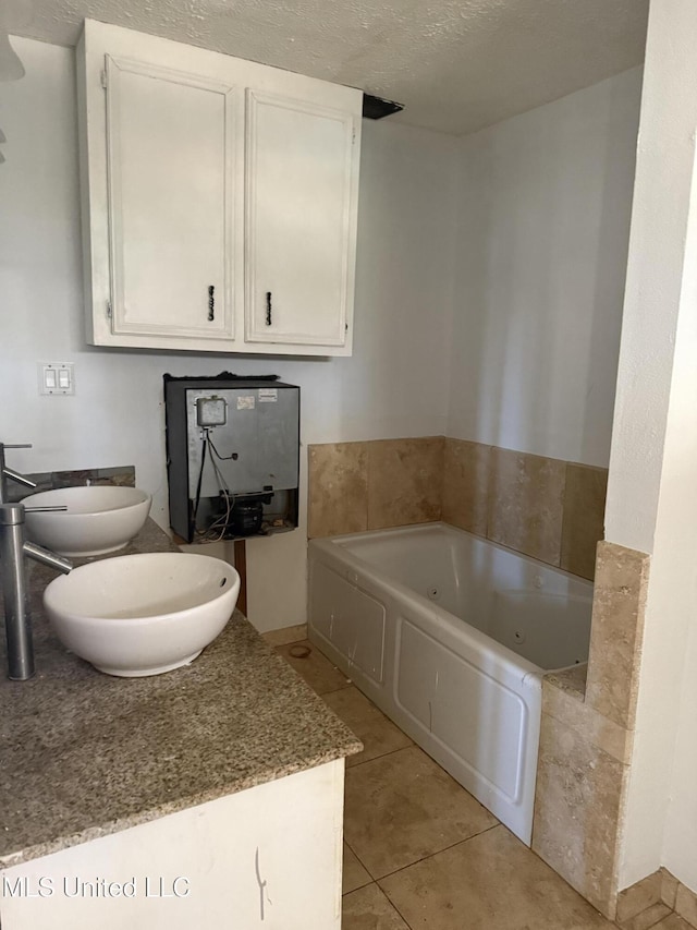 bathroom featuring a textured ceiling, tile patterned flooring, toilet, a bath, and a bidet