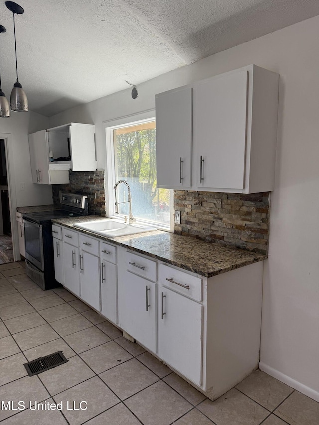 kitchen with stainless steel range with electric cooktop, white cabinetry, backsplash, hanging light fixtures, and sink