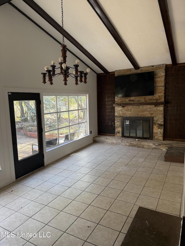 unfurnished living room featuring an inviting chandelier, light tile patterned flooring, vaulted ceiling with beams, and a stone fireplace