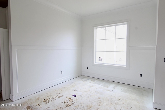 empty room featuring crown molding and a wealth of natural light