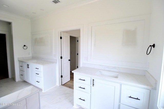 bathroom with marble finish floor, visible vents, ornamental molding, and vanity