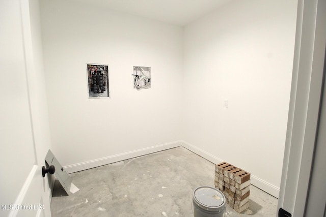 interior space featuring concrete flooring and baseboards