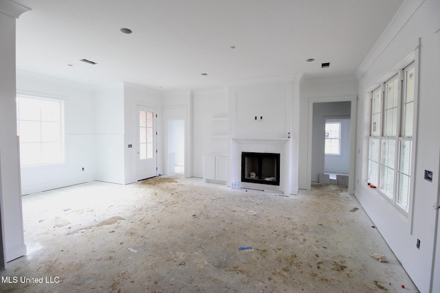 unfurnished living room featuring ornamental molding and a fireplace