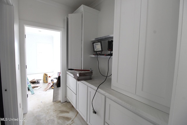 interior space featuring unfinished concrete flooring