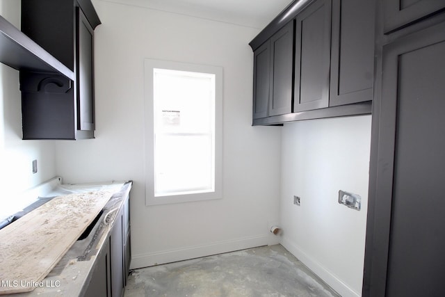 washroom featuring cabinet space and baseboards