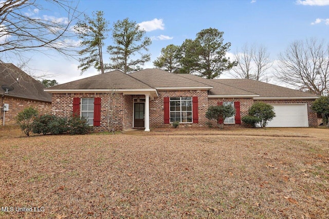 ranch-style home featuring a garage and a front lawn