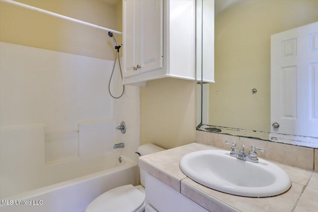 full bathroom featuring vanity, washtub / shower combination, and toilet