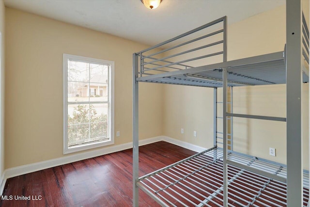 unfurnished bedroom with hardwood / wood-style flooring